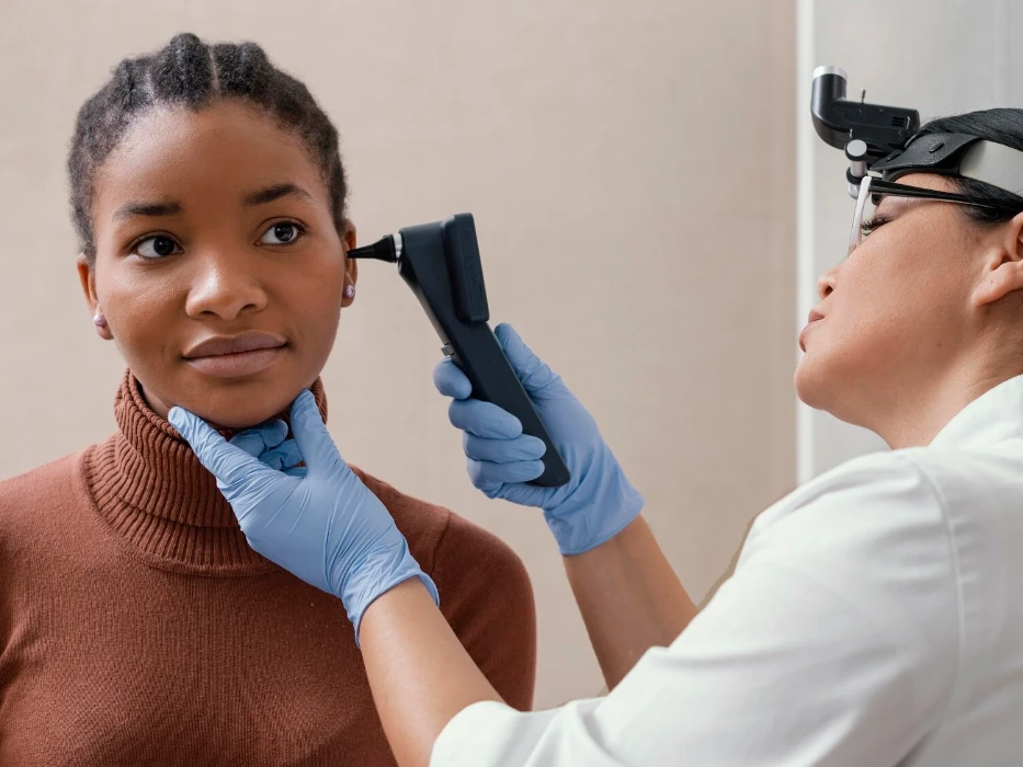 Medium shot doctor checking patient ears